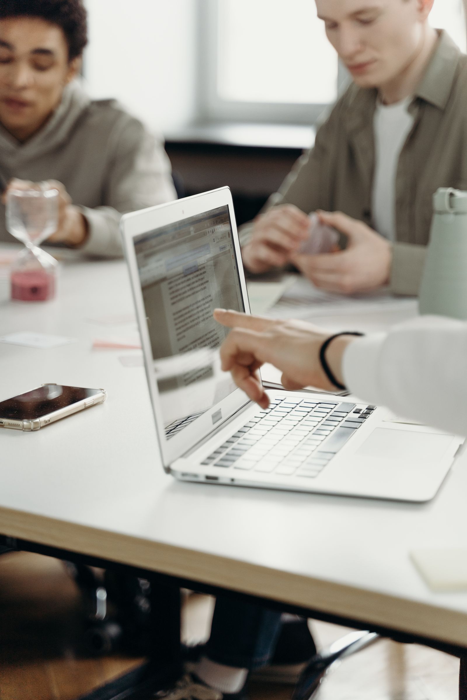 Attorneys working at laptops in a firm office